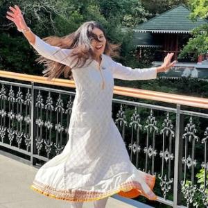 Ashwini dressed in a traditional Indian outfit crossing a bridge. 