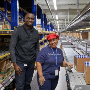 Two associates packing boxes