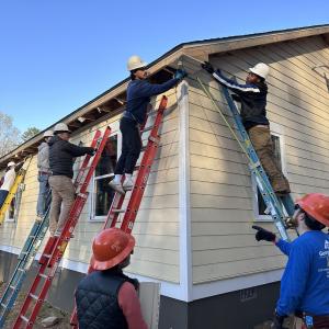 Georgia-Pacific volunteers repair siding on a house