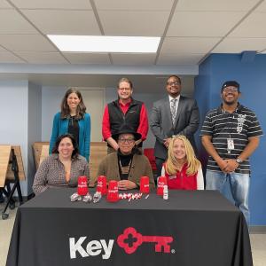 Auberle and Neighborhood Allies team member shown in photo behind a table.