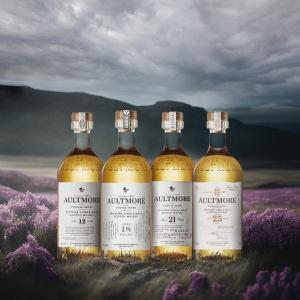 Four bottles of Aultmore on a digitized storm sky and landscape.