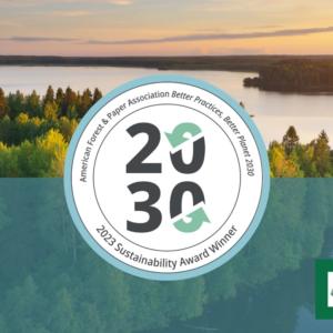 Over an aerial landscape of a lush forest and waterway, "2030 2023 Sustainability Award Winner" logo.