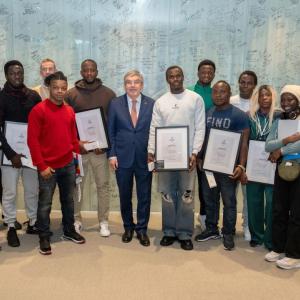 A group of people stood in a line holding awards