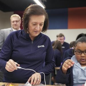 Otis Chair, Chief Executive Officer and President, Judy Marks builds robot with Boys and Girls Club member