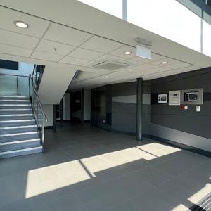 interior of an office building, a staircase on the left side wall