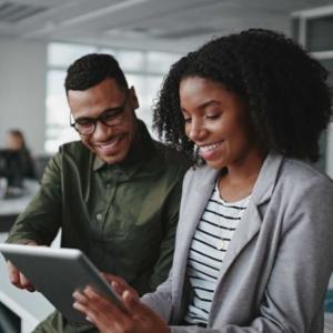 Two people looking at a tablet together