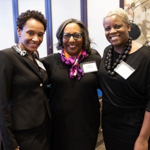 Three people posed together