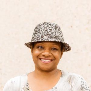 Headshot of a person wearing a hat