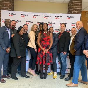 KeyBank and Bank Tank team members shown in front of a KeyBank banner.