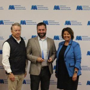 People standing with trophy