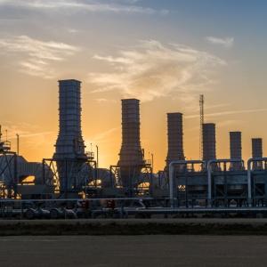 Smoke stacks in the skyline at sunset