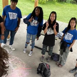 teens in Youth Central t-shirts and the photographer smiling in the foreground