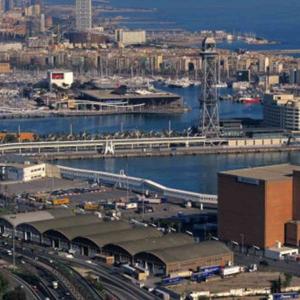 aerial view of a busy port in Barcelona. Many ships, buildings and piers