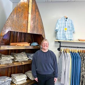 A person stood inside a clothes shop