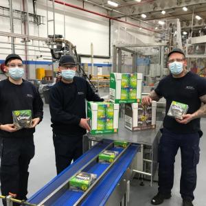 Several of Kimberly-Clark's employees hold Kleenex® products at the company's Barrow manufacturing facility in the UK.