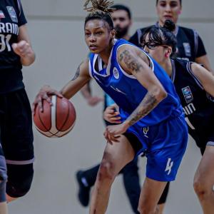Ashanti Hunt wearing a blue jersey playing basketball 