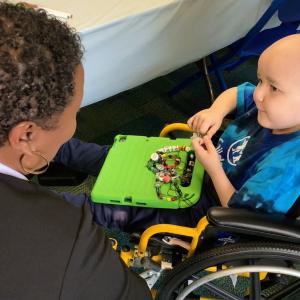 Aflac volunteers helping Dewey pick out even more beads to add to his collection.