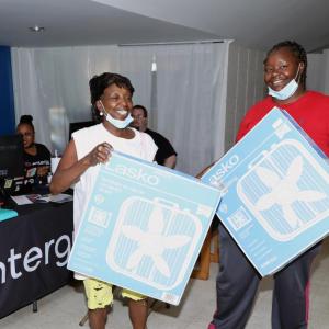 2 people holding box fans