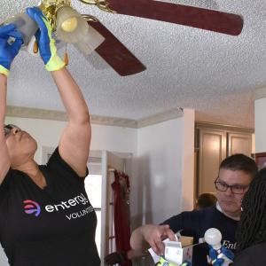 Entergy employee installs a ceiling fan