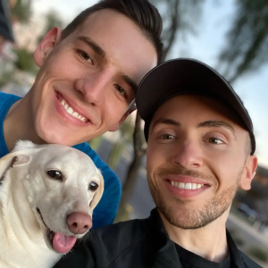 Ben and his husband holding his dog.