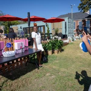 Photo of a woman posing while another woman takes her photo