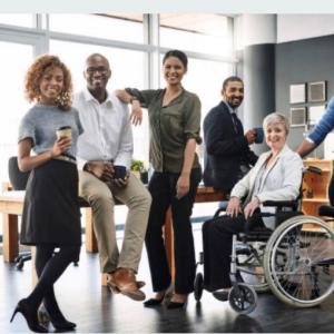 Group of employees seated, standing and in a wheelchair.