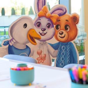 The Aflac special duck shown with a bunny and a bear.