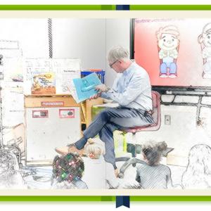 Bill Bateman reading to a classroom of children