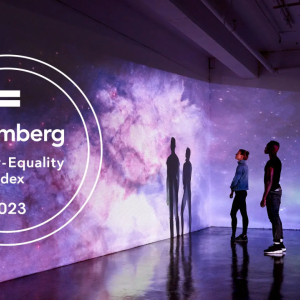 Two people looking at a large projected screen of a galaxy of stars, clouds in purples and blues. Lenovo logo on the right and the Bloomberg Gender Equality Index 2023 badge on the left.