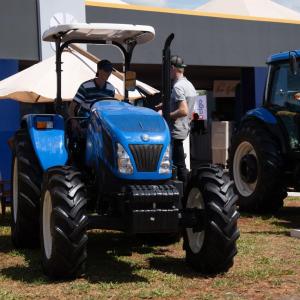 A person sat on a blue tractor 