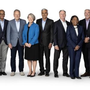 A group of people in business attire standing posed for the camera.