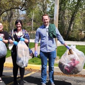 A group of people holding trash bags