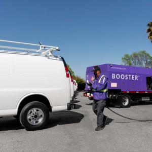 Booster tanker fueling a white van