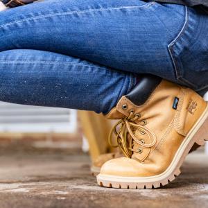 Person crouching down wearing jeans and Timberland boots