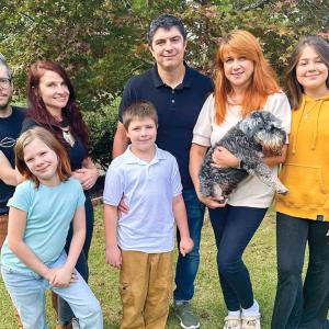 The Sviatyi family and host family posed outside