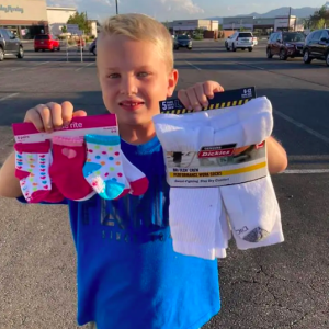 Young boy holding up socks