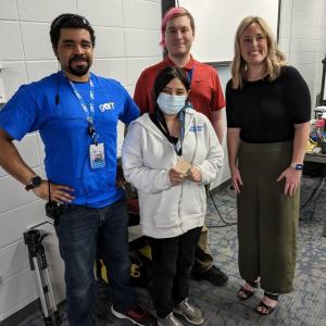 Group of four people smiling