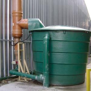large green enclosed tank outside a building