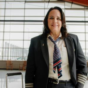Captain Bridget Van Scoy wearing uniform inside an airport 