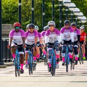 Riders crossing a bridge in a peloton.