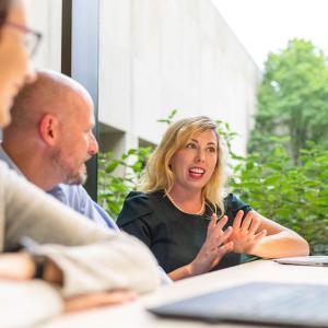 Julie Meade, PhD, scientific writer, Global Scientific and Regulatory Documentation, collaborates with colleagues in her role at Bristol Myers Squibb.