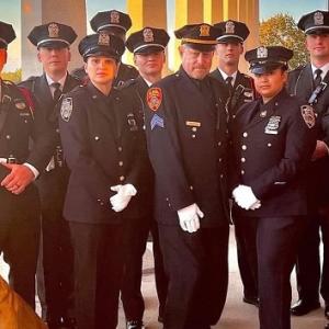 A group of police officers in dress uniforms standing in an outdoor structure.