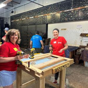 KeyBank volunteers preparing to assemble a bedframe.
