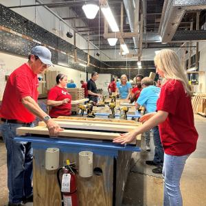 KeyBank volunteers laying out the bedframes.