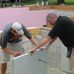 two people building a wall