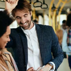 people stand while riding on a bus