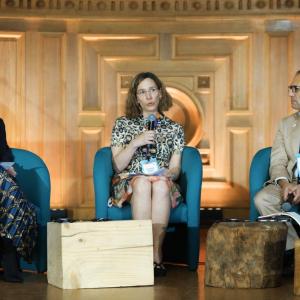 Rebecca Marmot, Leanne Geale, and Michael Goltzman speaking together on stage.