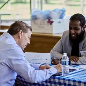 2 people sitting at a table together