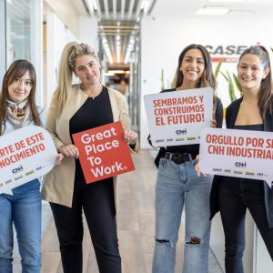 4 people holding signs celebrating Great Place to Work certification