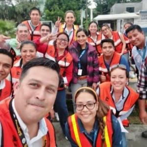 A group of volunteers posed in safety vests.